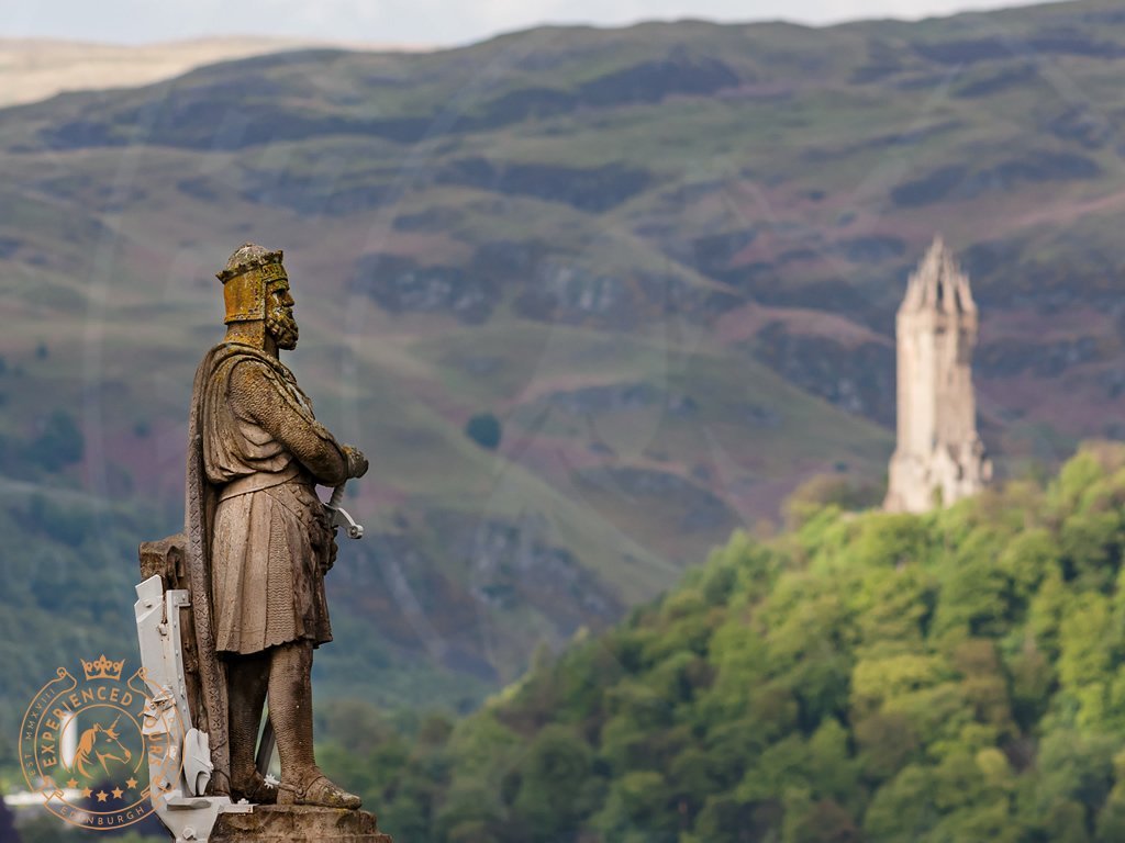 Looking past Robert The Bruce to The Wallace Monument